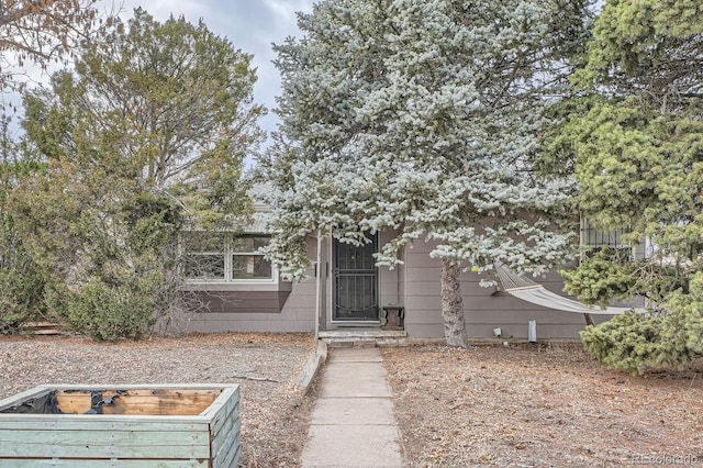 view of property hidden behind natural elements