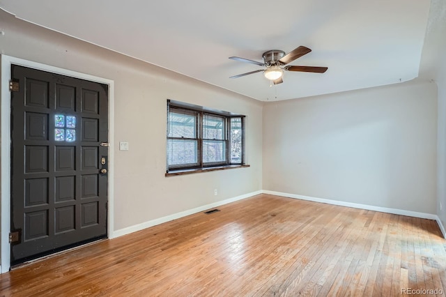 entryway featuring a ceiling fan, wood-type flooring, and baseboards