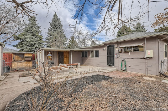 view of front of home featuring fence and a patio