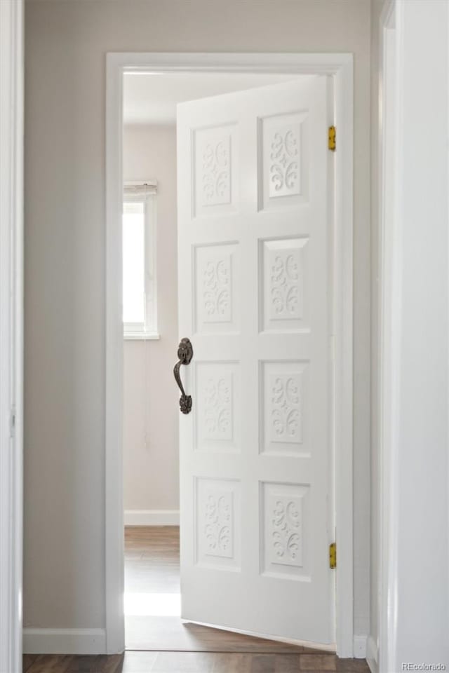 interior space featuring baseboards and wood finished floors