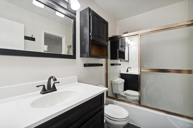 full bathroom with toilet, enclosed tub / shower combo, and vanity