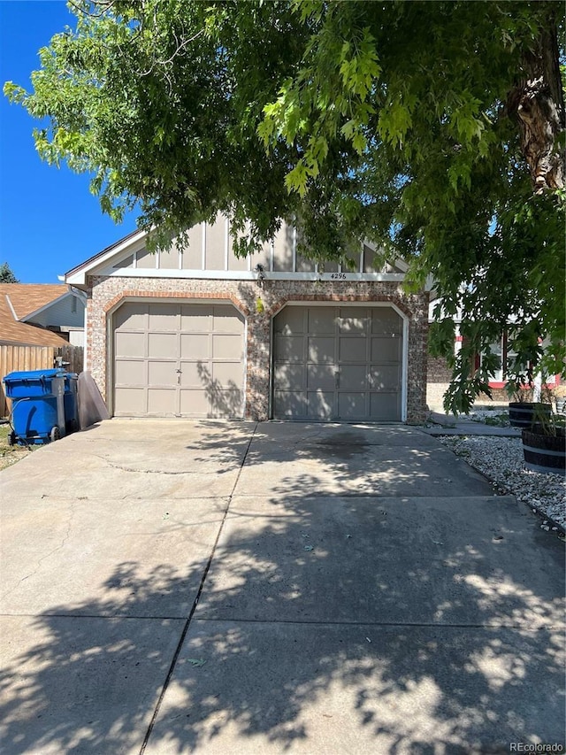 view of front of house featuring concrete driveway and brick siding