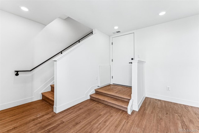 staircase featuring hardwood / wood-style flooring