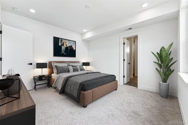 bedroom featuring light carpet