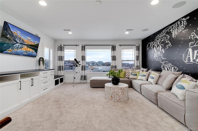 carpeted living room with a healthy amount of sunlight