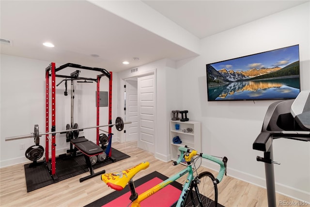 exercise room featuring hardwood / wood-style floors