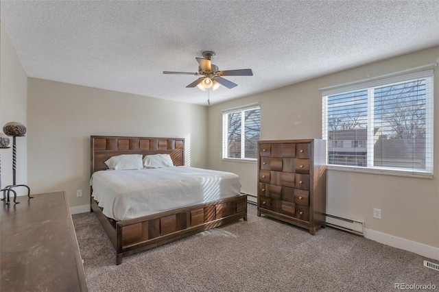 bedroom featuring baseboard heating, ceiling fan, carpet, and a textured ceiling