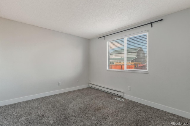 spare room with carpet floors, a baseboard radiator, and a textured ceiling