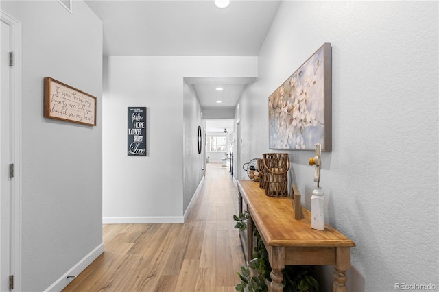 corridor with light wood-type flooring