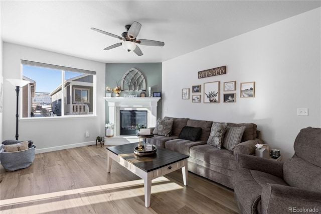 living room featuring ceiling fan and light hardwood / wood-style flooring