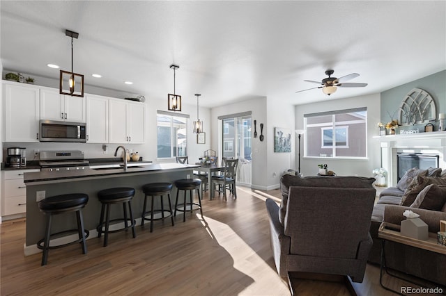 kitchen with pendant lighting, appliances with stainless steel finishes, and white cabinets