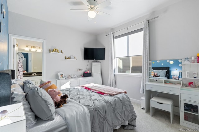 carpeted bedroom featuring ceiling fan and ensuite bathroom