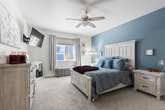 bedroom with ceiling fan and light carpet