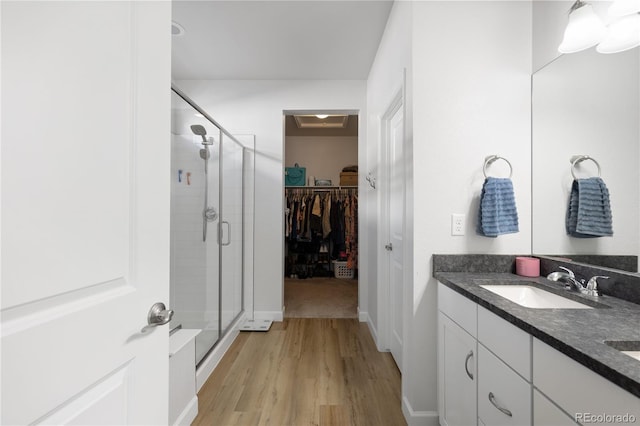 bathroom featuring vanity, an enclosed shower, and hardwood / wood-style floors