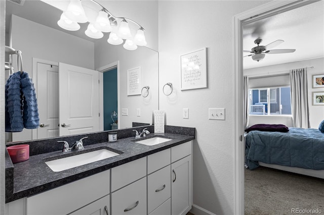 bathroom featuring vanity and ceiling fan with notable chandelier