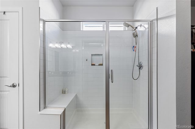 bathroom with a shower with door