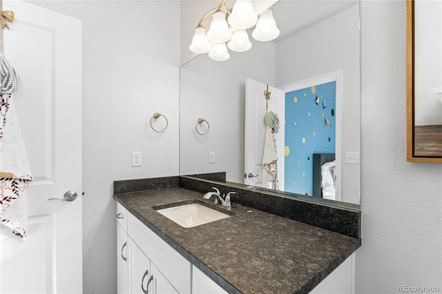 bathroom with vanity and a notable chandelier