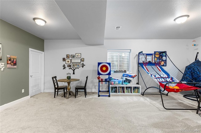 playroom with carpet and a textured ceiling