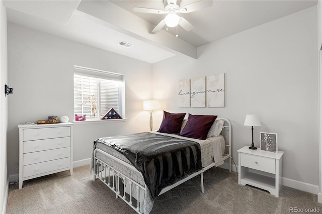 bedroom with beamed ceiling, carpet, and ceiling fan