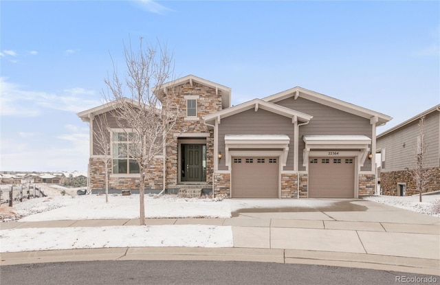 craftsman inspired home with stone siding and concrete driveway