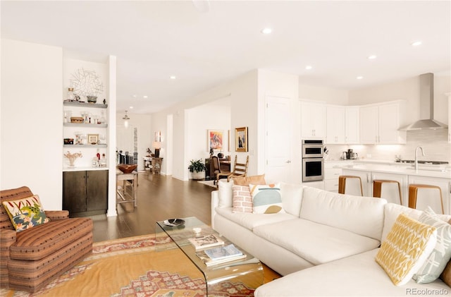 living room with recessed lighting and wood finished floors