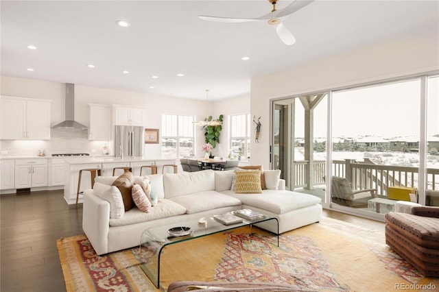 living area featuring wood finished floors, recessed lighting, and a healthy amount of sunlight