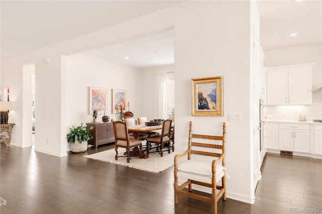 dining space with recessed lighting, baseboards, and dark wood finished floors