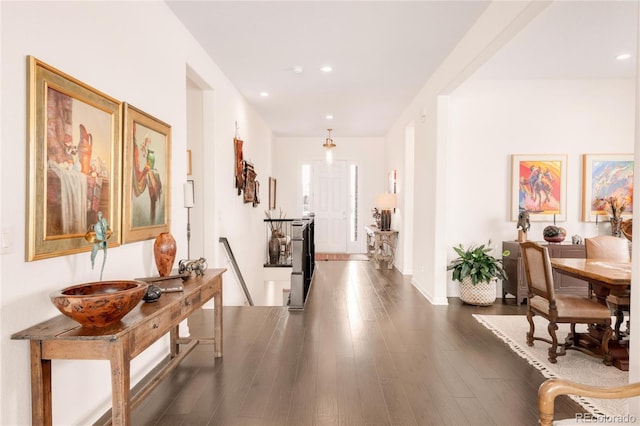 corridor with dark wood-style floors, recessed lighting, and baseboards