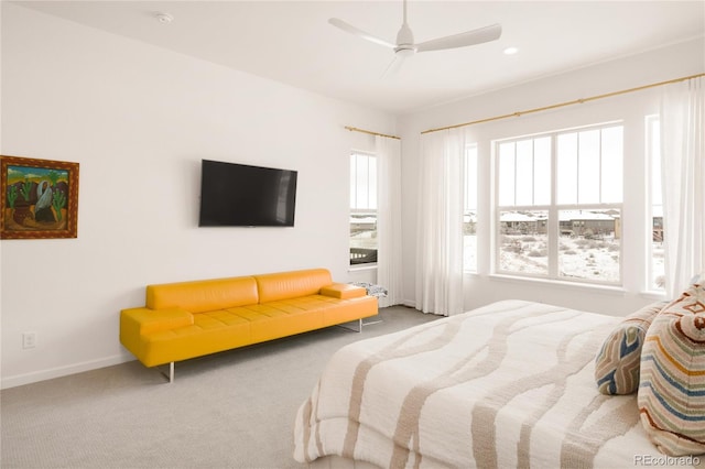 carpeted bedroom with baseboards and a ceiling fan