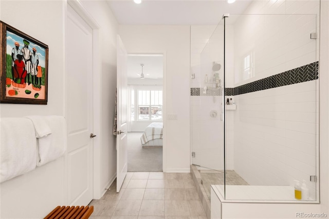 ensuite bathroom with ensuite bathroom, recessed lighting, tiled shower, tile patterned flooring, and baseboards