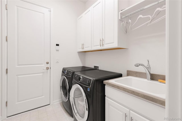 laundry room featuring a sink, cabinet space, and washing machine and dryer