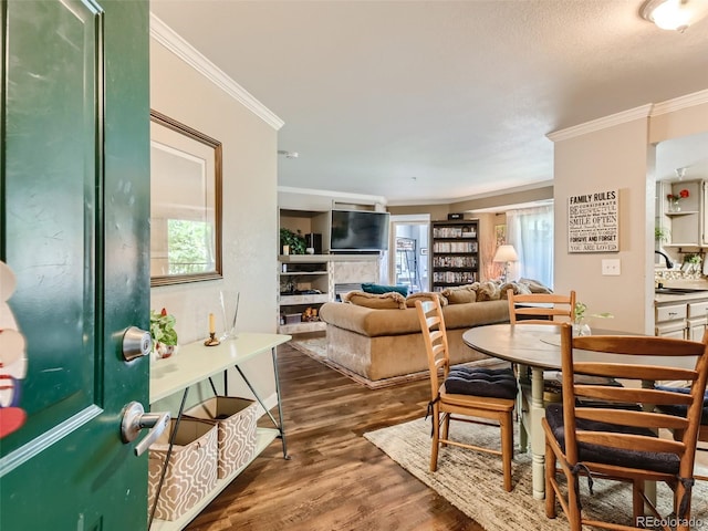 living room featuring ornamental molding, plenty of natural light, and dark hardwood / wood-style flooring