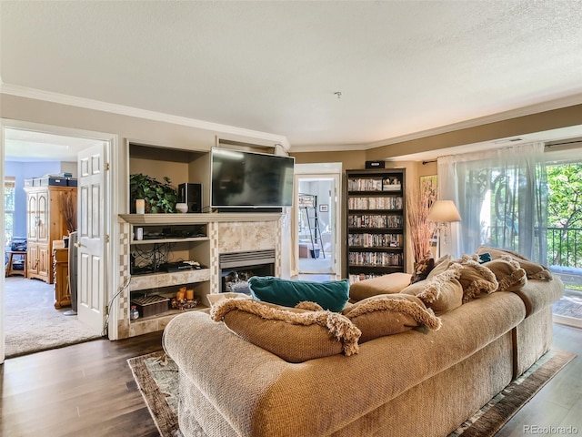 living room featuring a textured ceiling, a fireplace, dark hardwood / wood-style floors, and ornamental molding