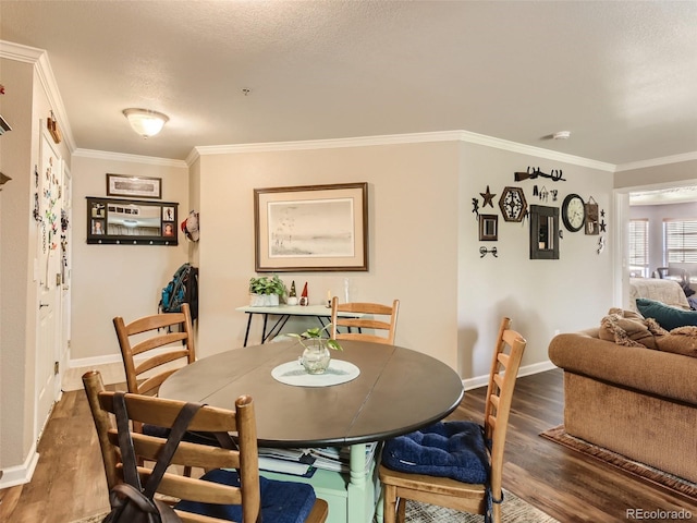 dining room featuring crown molding, dark hardwood / wood-style floors, and a textured ceiling