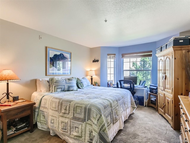 carpeted bedroom featuring a textured ceiling