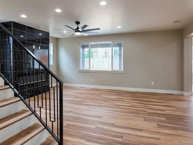 5550 Wetlands Dr, Longmont, CO 80504 - stairway with wood finished floors, recessed lighting, and ceiling fan