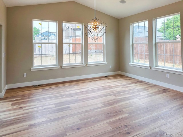 5550 Wetlands Dr, Longmont, CO 80504 - unfurnished room with light wood finished floors, a chandelier, and vaulted ceiling