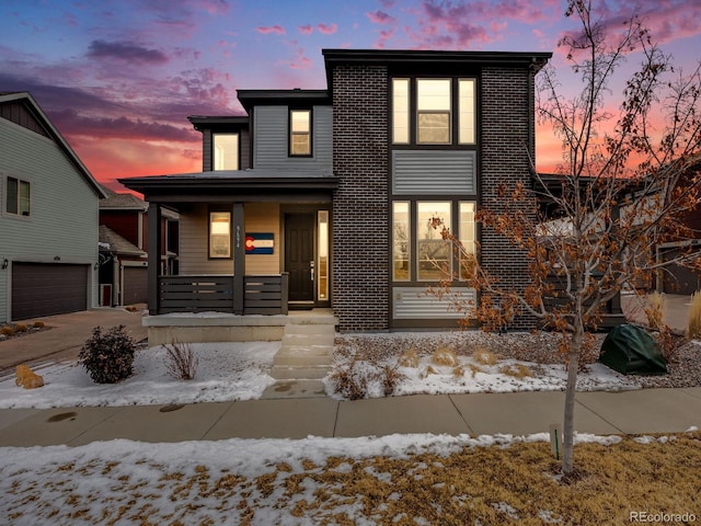 contemporary home with driveway and a porch