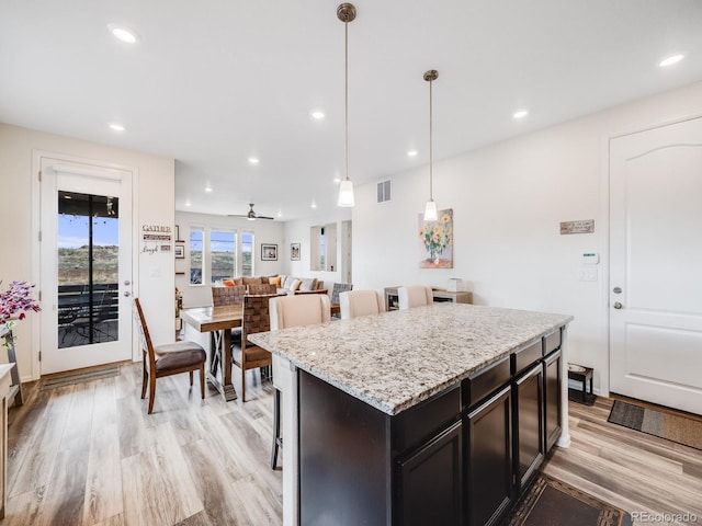 kitchen with visible vents, light wood-style flooring, recessed lighting, and a kitchen island