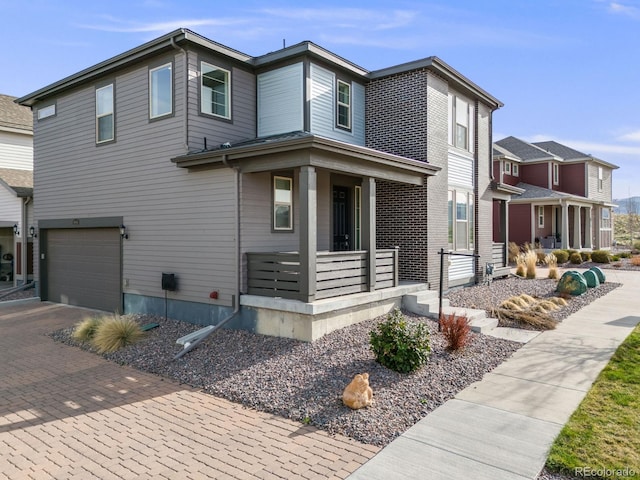 view of front of property with a porch, a garage, and decorative driveway