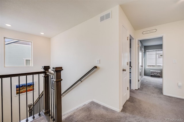 stairs with visible vents, baseboards, recessed lighting, and carpet floors