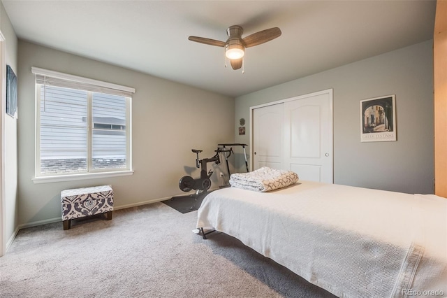 bedroom featuring a closet, baseboards, a ceiling fan, and carpet flooring