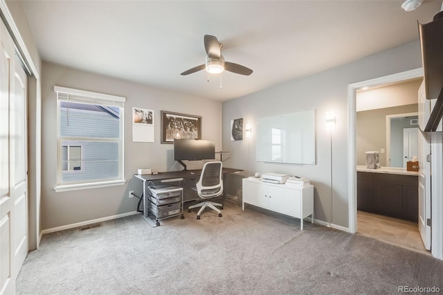 office area with light carpet, plenty of natural light, baseboards, and a ceiling fan