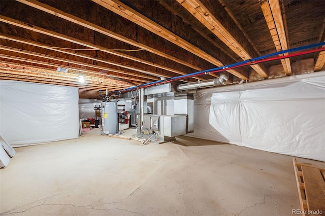 unfinished below grade area featuring heating unit and gas water heater
