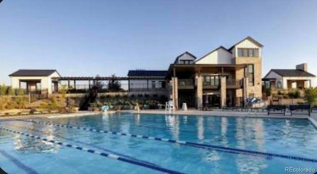 pool featuring a patio and fence