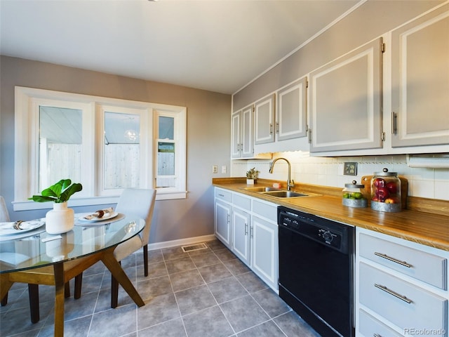 kitchen featuring decorative backsplash, black dishwasher, white cabinetry, and wooden counters