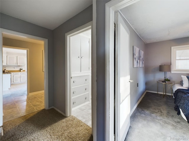 corridor featuring light colored carpet