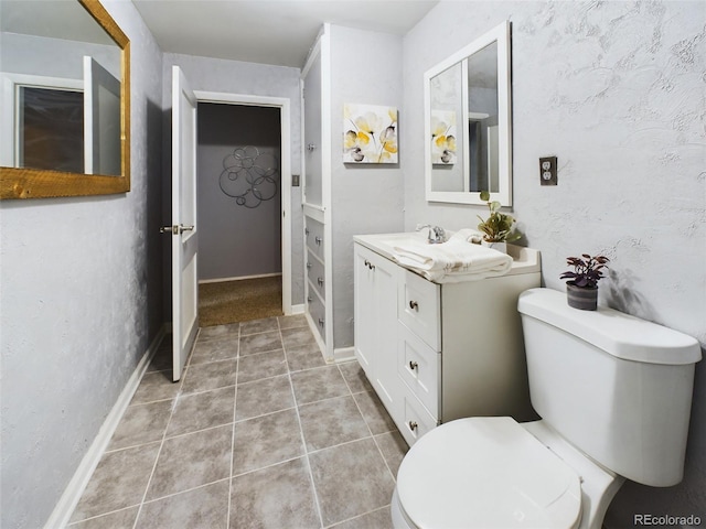 bathroom featuring tile patterned floors, vanity, and toilet