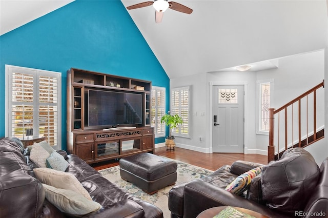 16841 E Hialeah Ave, Centennial, CO 80015 - living room featuring high vaulted ceiling, a ceiling fan, wood finished floors, and stairs