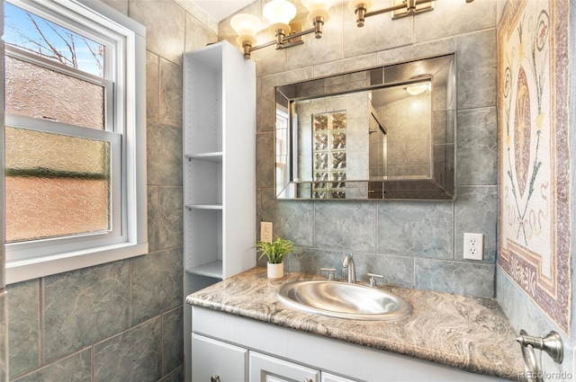 16841 E Hialeah Ave, Centennial, CO 80015 - bathroom with vanity, tasteful backsplash, and tile walls